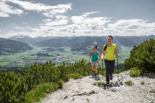 two girls hiking on a trail in Saalfelden-Leogang