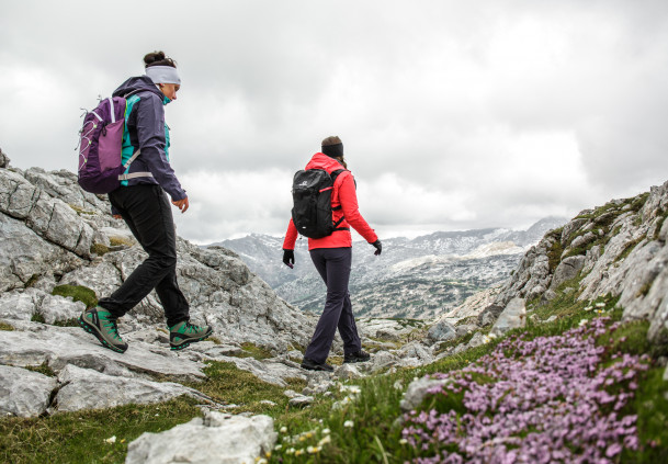 two hikers on the way in the railing of the mountains in Saalfelden-Leogang